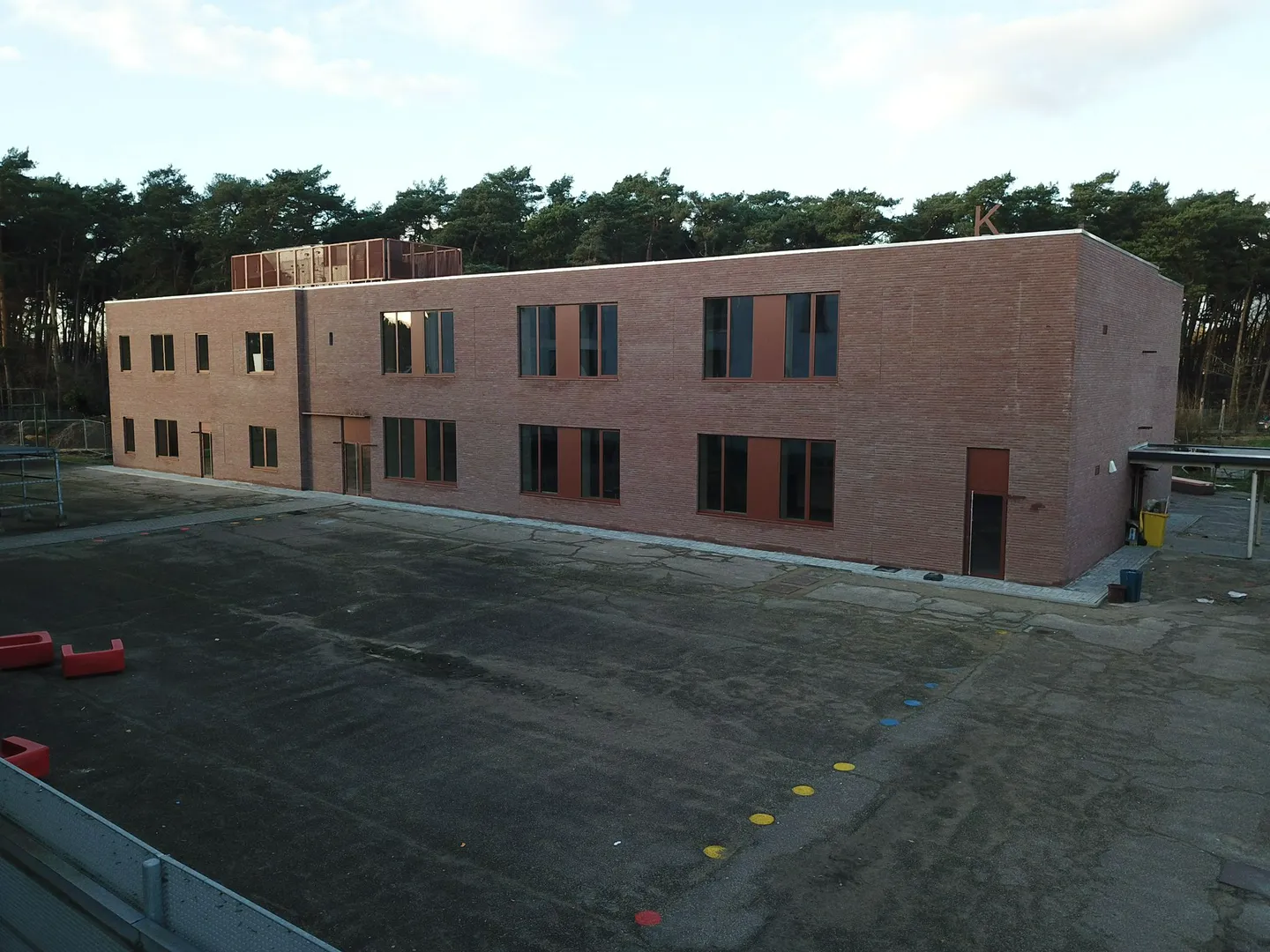 Elewacje domu – dwukondygnacyjny budynek z ceglaną elewacją i zamontowanymi oknami